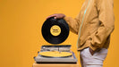 Free Side View Of Man Holding Vinyl Disk For Music Store Mock-Up Psd