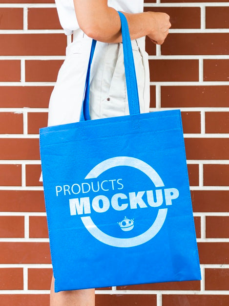 Free Side View Woman Holding A Plain Blue Bag Mock-Up Psd