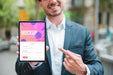 Free Smiley Businessman Holding And Pointing At Tablet Psd