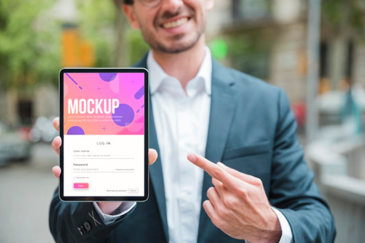 Free Smiley Businessman Holding And Pointing At Tablet Psd