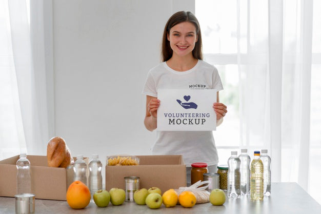 Free Smiley Female Volunteer Holding Blank Page While Preparing Food For Donation Psd
