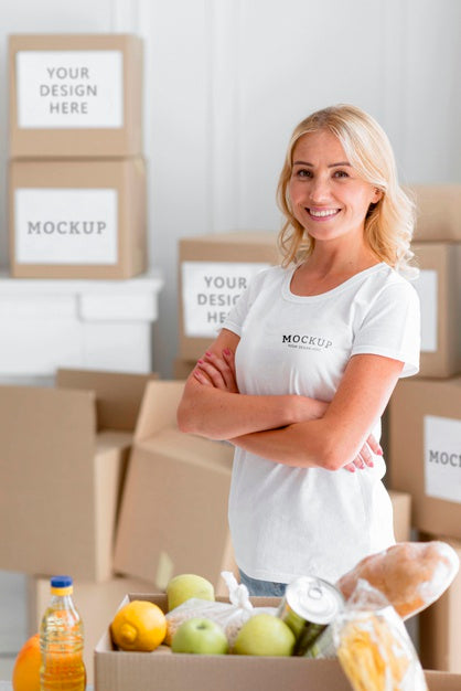 Free Smiley Female Volunteer Posing Next To Food Box Psd