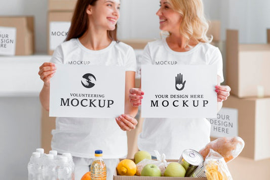 Free Smiley Female Volunteers Holding Blank Papers Next To Food Box Psd