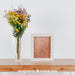 Free Spring Mockup With Vertical Frame And Vase Of Flowers Over Table Psd