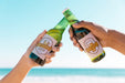 Free Toasting With Two Beet Bottles At The Beach Psd