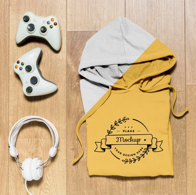Free Top View Folded Hoodie Mock-Up With Controllers And Headphones Psd