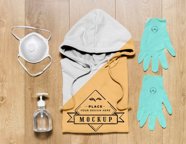 Free Top View Folded Hoodie Mock-Up With Gloves, Mask And Hand Sanitizer Psd