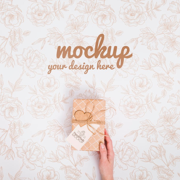 Free Top View Hand Holding Birthday Present With Mock-Up Psd
