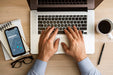 Free Top View Man Using Laptop Near Phone Mock-Up Psd