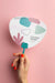 Free Top View Of Female Hands Holding Mock-Up Paper Fan Psd