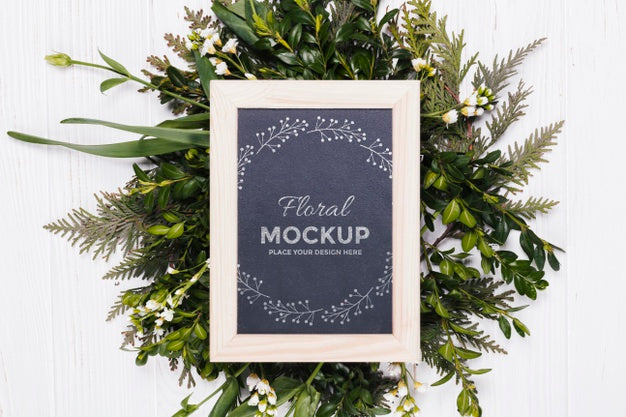 Free Top View Of Frame Mock-Up With Vegetation Wreath Psd