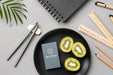 Free Top View Of Paper Stationery On Plate With Kiwi And Rulers Psd