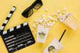 Free Top View Of Popcorn Cup With Clapperboard And Glasses Psd