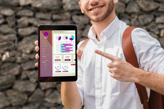 Free University Man Holding And Pointing At Tablet Psd