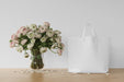 Free White Bag And Flowers In A Vase Psd