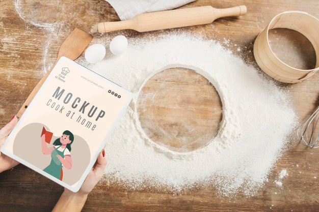Free Woman Holding Book In The Kitchen With Flour And Sieve Psd
