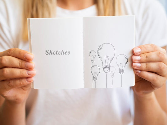 Free Woman Holding Up A Sketch Book Mock-Up Psd