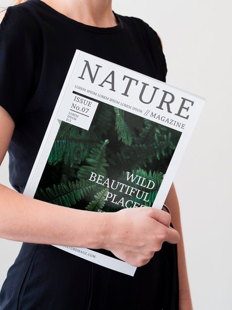 Free Woman In A Black Dress Holding A Magazine Mock Up Psd