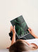 Free Woman Lain Down And Holding A Nature Magazine Psd
