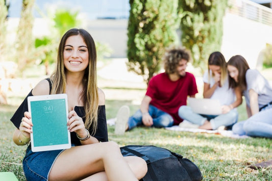 Free Woman Showing Tablet Mockup In Park Psd
