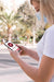 Free Woman With Mask On Street Reading Book On Phone Psd
