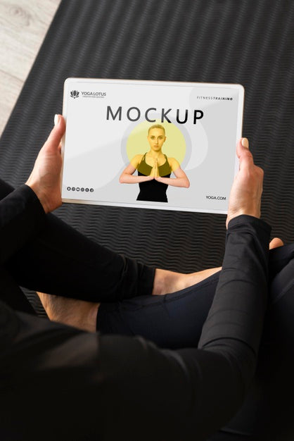 Free Yoga Instructor Holding A Tablet Mock-Up Psd